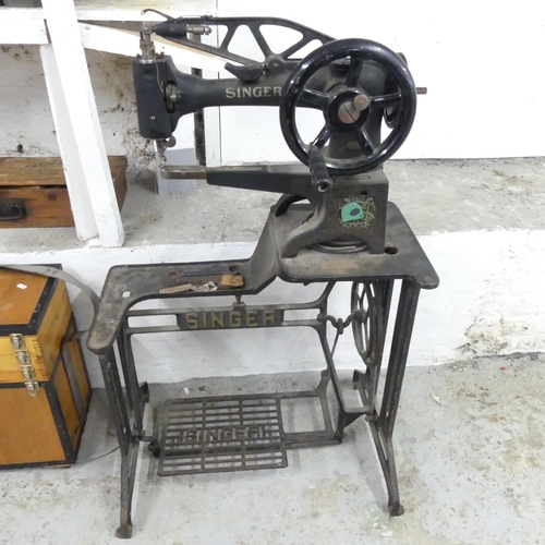 2586 - A Singer treadle sewing machine on metal base. Overall 76x112x36cm.