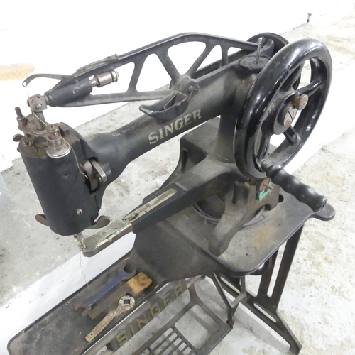 2586 - A Singer treadle sewing machine on metal base. Overall 76x112x36cm.