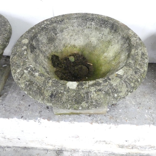 2597 - Three weathered concrete two-section garden urns on stands. 59x40cm.