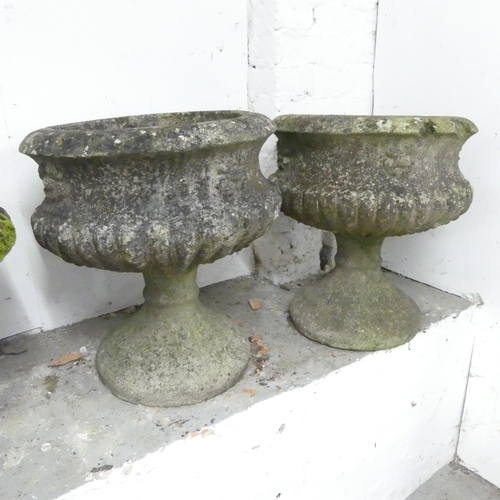 2598 - A pair of weathered concrete two-section garden urns. 43x49cm.