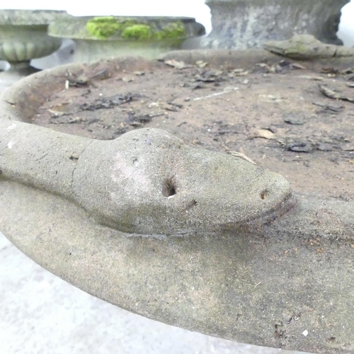 2599 - A two-section weathered concrete bird bath, with serpent decoration. 72x90cm.