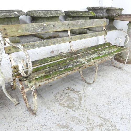 2600 - A teak slatted garden bench with cast iron ends. 180x82x55cm.