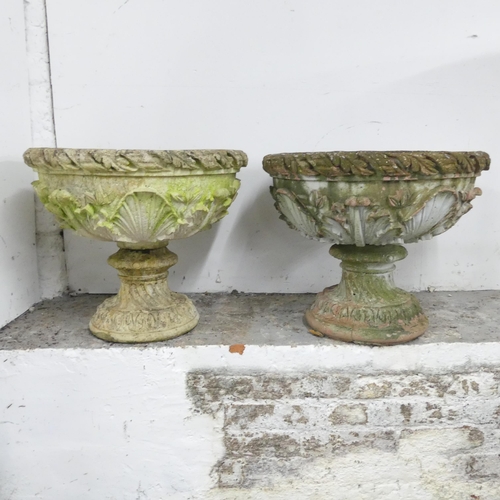 2601 - A pair of weathered concrete two-section continental style garden urns. 55x47cm.