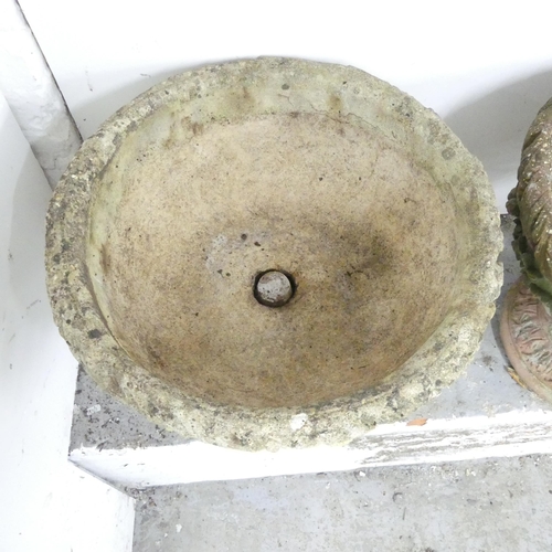 2601 - A pair of weathered concrete two-section continental style garden urns. 55x47cm.