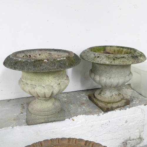 2608 - A pair of two-section weathered concrete garden urns. 53x50cm.