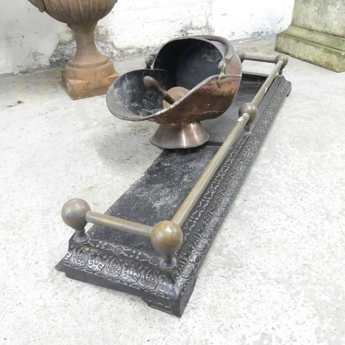 2609 - A cast iron fire surround, 120x16x29cm, and a copper coal scuttle with shovel. (2)