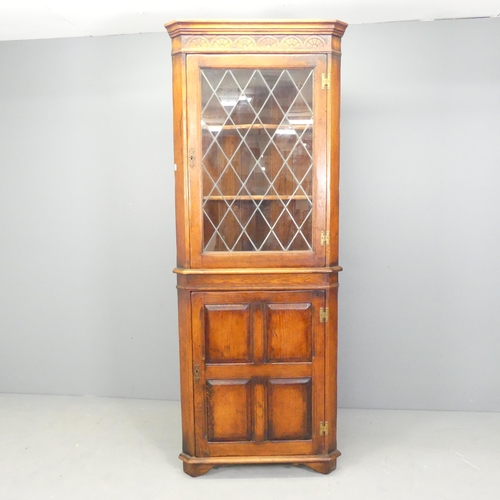 2623 - A Georgian style panelled oak two-section corner cupboard. 73x191x40cm.