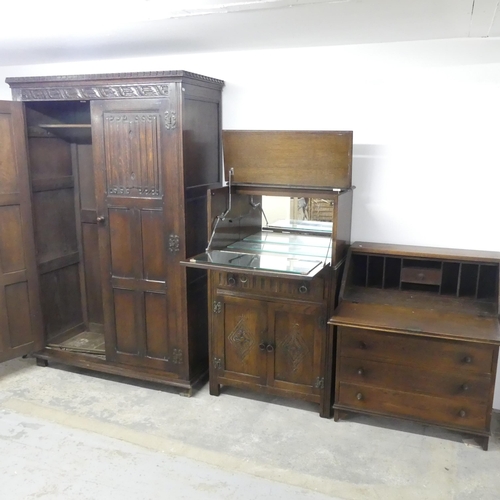 2626 - An early 20th century panelled oak two door wardrobe with linenfold decoration and label for S. Good... 