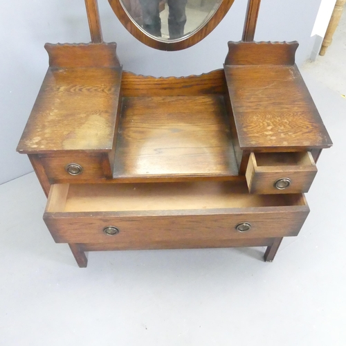 2638 - An oak Arts & Crafts style dressing chest, with raised mirror back and two short and two long drawer... 