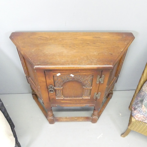 2655 - An oak credence cupboard of canted form with label for Old Charm, 81x71x33cm, and two Lloyd loom cha... 