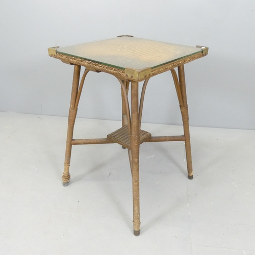 2658 - A vintage rattan side table, with square glass top. 48x71cm.