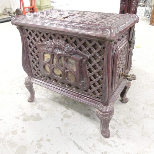 2660 - A French cast iron wood burning stove. Overall 56x52x34cm.