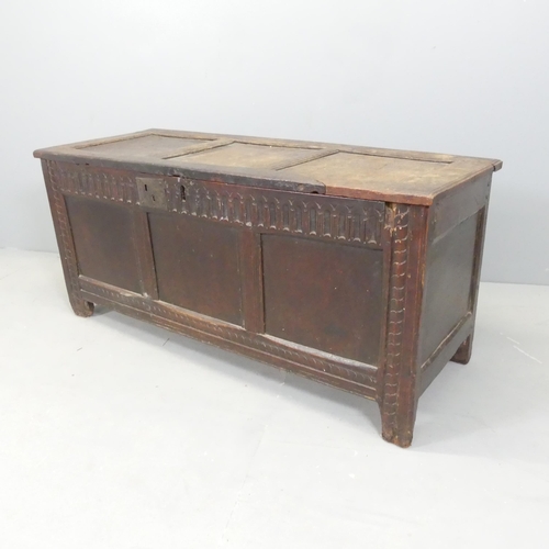 2668 - An antique panelled oak coffer, with carved linenfold decoration and raised on stile legs. 121x56x48... 