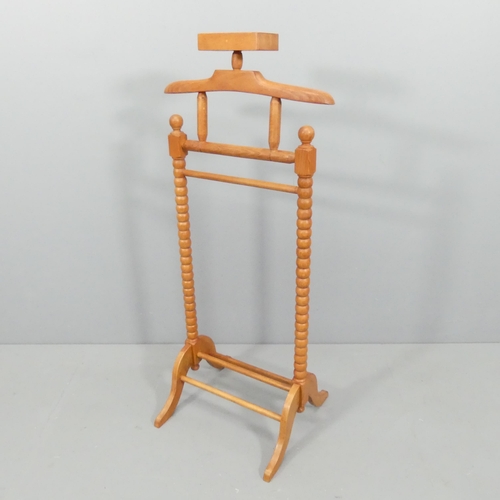 2679 - A stained beech dumb-valet stand. 54x120x25cm.