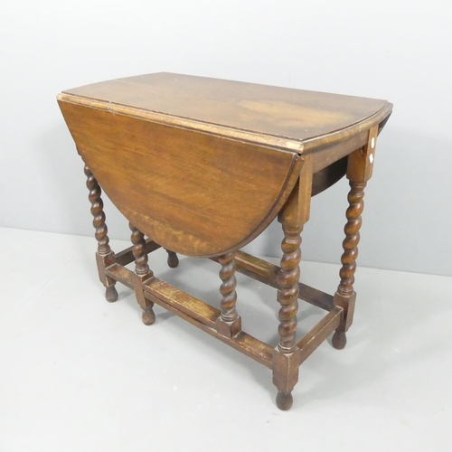 2681 - An antique oak oval gate-leg drop-leaf table on barley twist legs. 86x74x42cm.