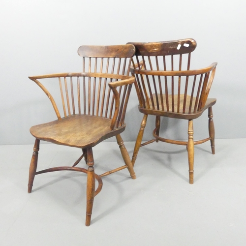 2228 - A near pair of yew-wood and elm-seated comb back Windsor bow arm chairs, with crinoline stretcher.