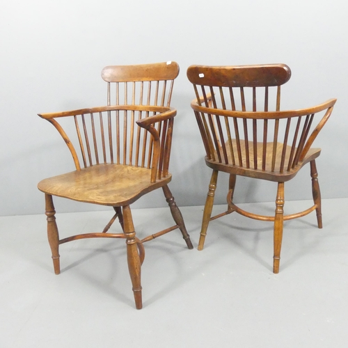 2229 - A near pair of yew-wood and elm-seated comb back Windsor bow arm chairs, with crinoline stretcher.