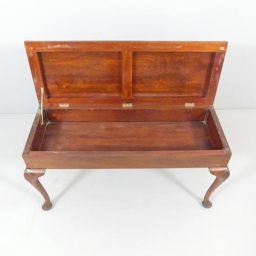 2230 - A 19th century mahogany and upholstered duet stool, with lifting seat, cabriole legs and applied car... 