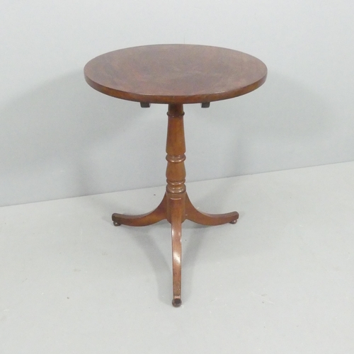 2235 - An antique mahogany circular tilt-top occasional table. 54x72cm.