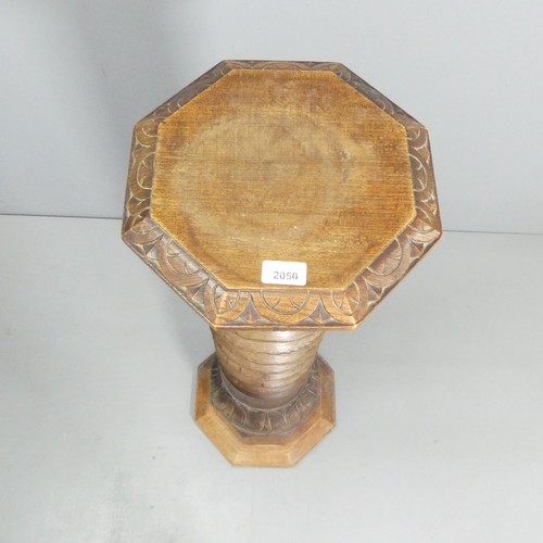 2050 - A large antique French elm spiral turned column with carved oak octagonal top, skirt and base. Carve... 