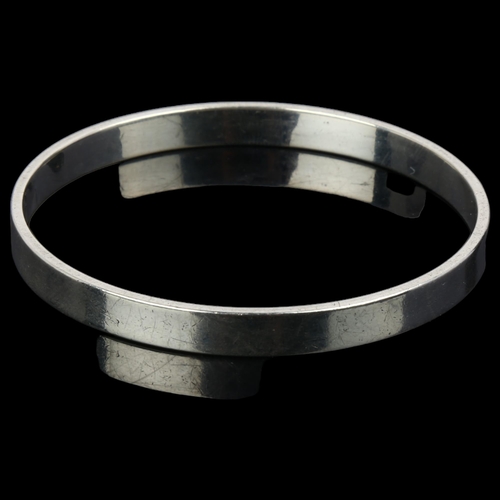 902 - RUDOLF ANDRESEN - a Danish silver plain form slave bangle, band width 6.6mm, internal circumference ... 