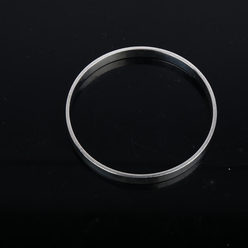 902 - RUDOLF ANDRESEN - a Danish silver plain form slave bangle, band width 6.6mm, internal circumference ... 