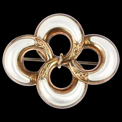 913 - A Norwegian sterling silver-gilt white enamel openwork brooch, maker JA, 41.1mm, 8.3g