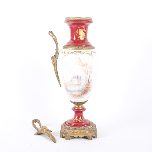 110 - A brass and ormolu mounted 2-handled ceramic urn, with hand painted and gilt decoration. H - 36cm.