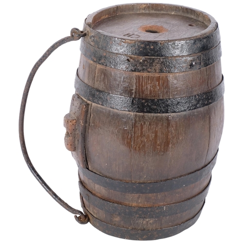 114 - A large iron bound farmer's harvest barrel, with carry handle. Initialed to top for 'CH'. L - 30cm.