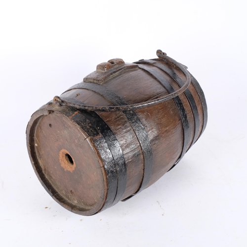 114 - A large iron bound farmer's harvest barrel, with carry handle. Initialed to top for 'CH'. L - 30cm.