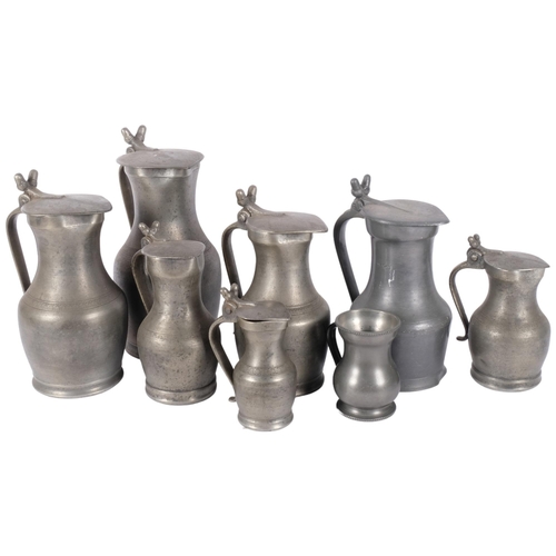 119 - A group of lidded pewter jugs, tallest 26.5cm, and a pewter mug