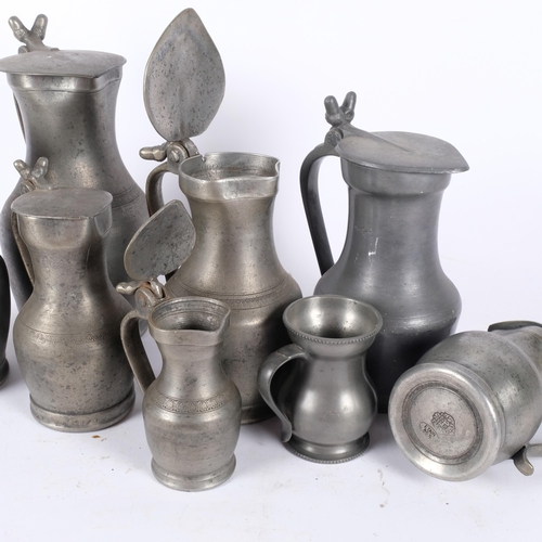 119 - A group of lidded pewter jugs, tallest 26.5cm, and a pewter mug