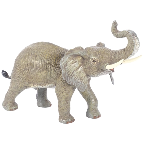 129 - An Oriental painted bronze trumpeting elephant, H22cm