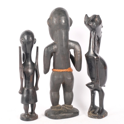 132 - A group of 3 carved hardwood figures, including 2 fertility and another. Largest - 46cm.