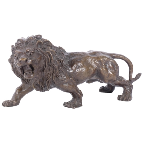 134 - A bronze sculpture of a roaring lion, H15cm, L32cm