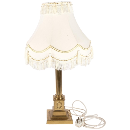 139 - A large brass Corinthian column table lamp with associated shade. H - 67cm.