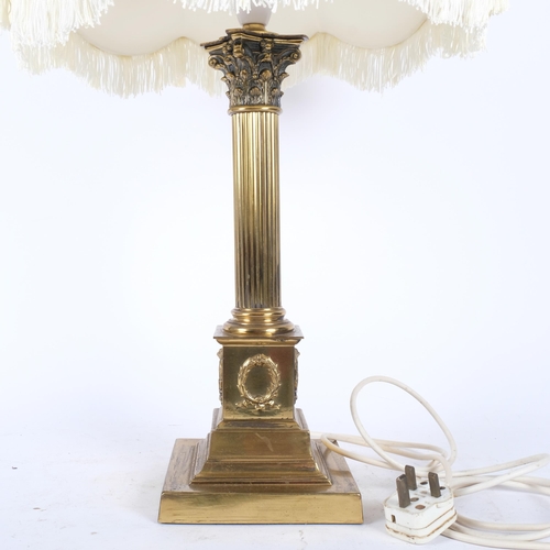 139 - A large brass Corinthian column table lamp with associated shade. H - 67cm.