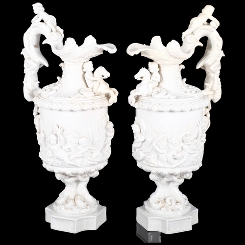 141 - A pair of continental ceramic ewers with embossed figural an cherub decoration. Both marked to under... 