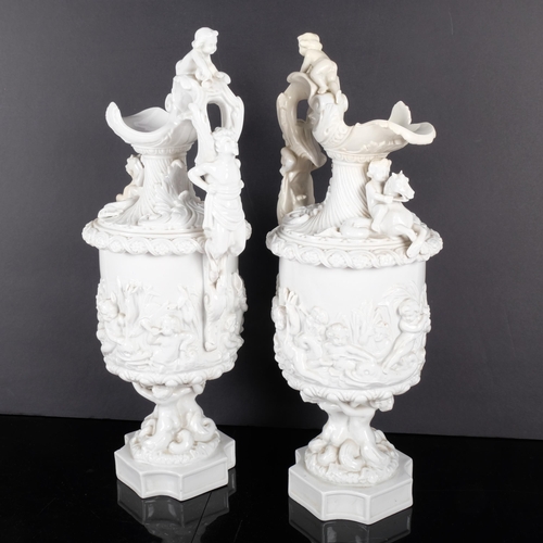 141 - A pair of continental ceramic ewers with embossed figural an cherub decoration. Both marked to under... 