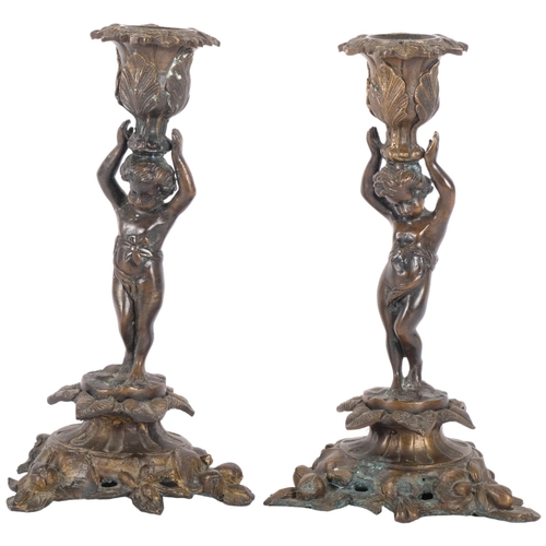 142 - A pair of gilt-bronze candle sticks with cherub design. H - 26cm.