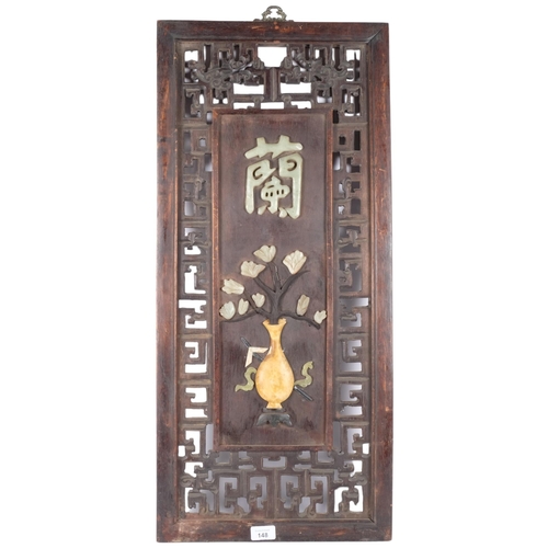 148 - A Chinese hardwood plaque with pierced and floral stone decoration. 82x37cm.