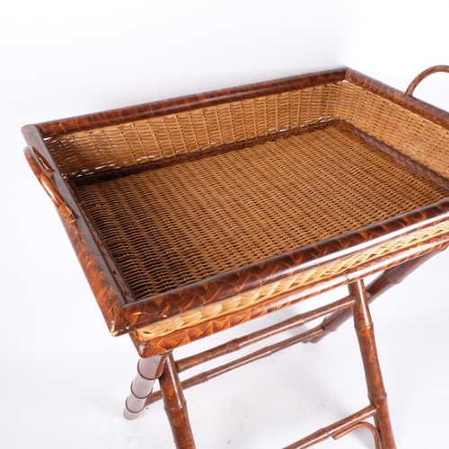 151 - A wicker and faux bamboo tray on folding stand. H - 72cm, L - 61cm, D - 46cm.