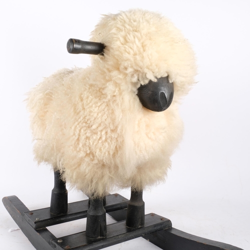 153 - A 1950s Scandinavian rocking horse, in the manner of a sheep, with real wool. L - 67cm.