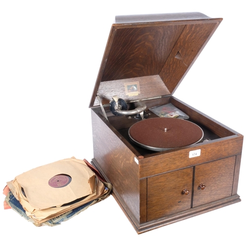 174 - 'HMV' - model 109 gramophone in oak case. With associated spare needle tins by Columbia and Dulcetto... 