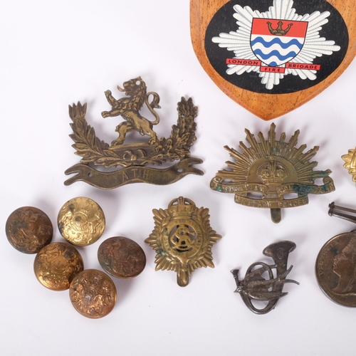 189 - A group of military buttons and badges and an oak plaque for the London Fire Brigade.