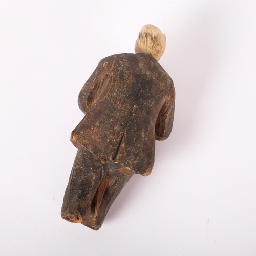 190 - An antique Folk Art carved wood and bone figure of a man playing the bagpipes. H - 15cm.