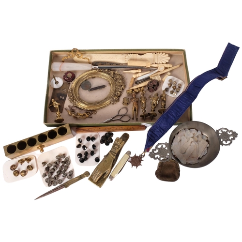 191 - A tray of various items, including a brass hand design paperclip, mother of pearl fish gaming counte... 