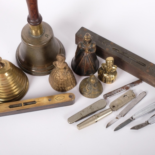 203 - A cast bell, with turned wood handle and clanger, a beehive design desk bell, a Preston and Sons ros... 