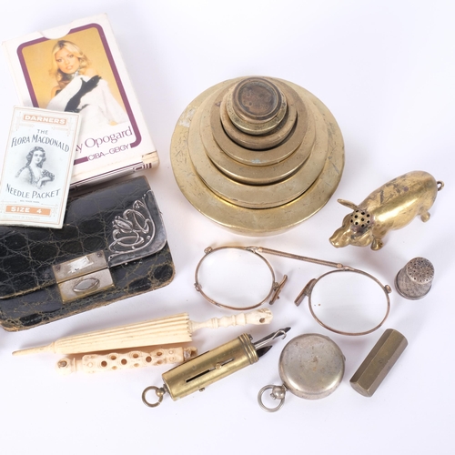 204 - A graduated set of brass weights, a brass pig censer, chrome plated sovereign case, playing cards, v... 