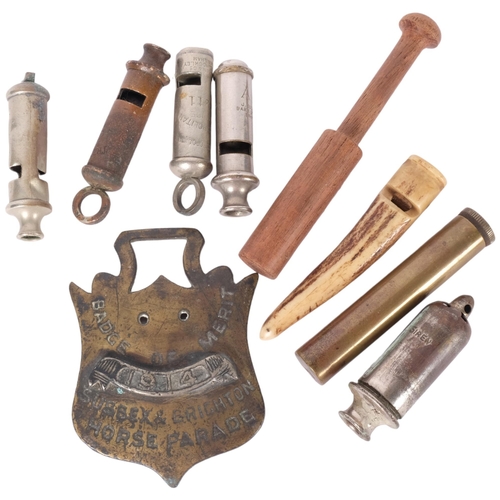 213 - A collection of various vintage whistles including horn, brass badge of merit for Sussex and Brighto... 